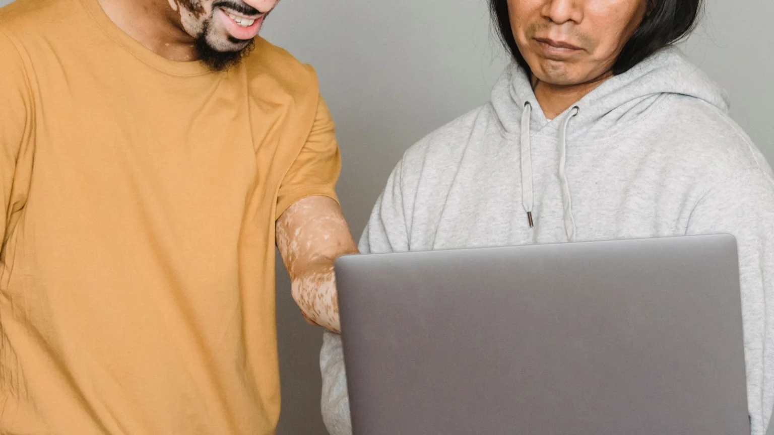 Two colleagues working together on a laptop