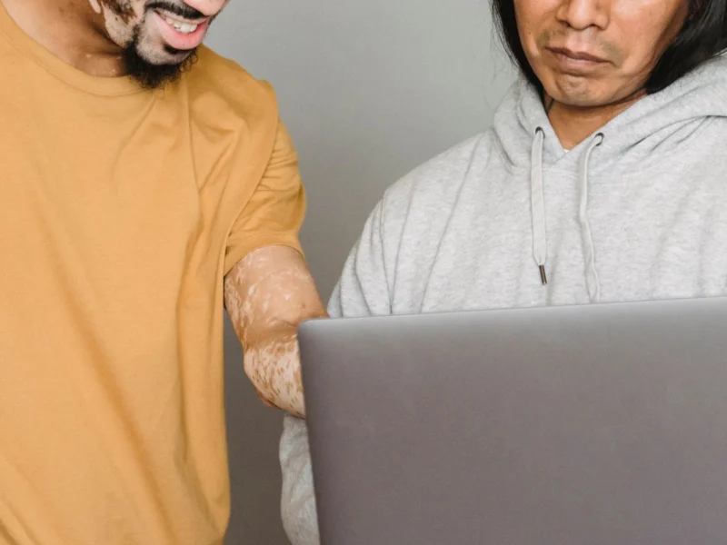 Two colleagues working together on a laptop