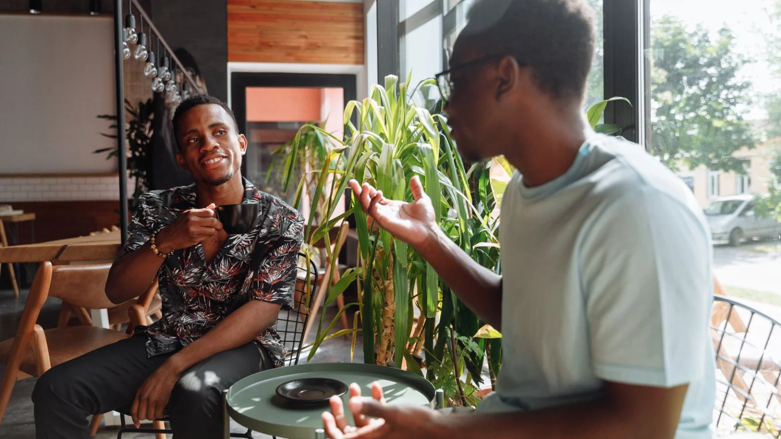 Two friends talking over coffee in a café