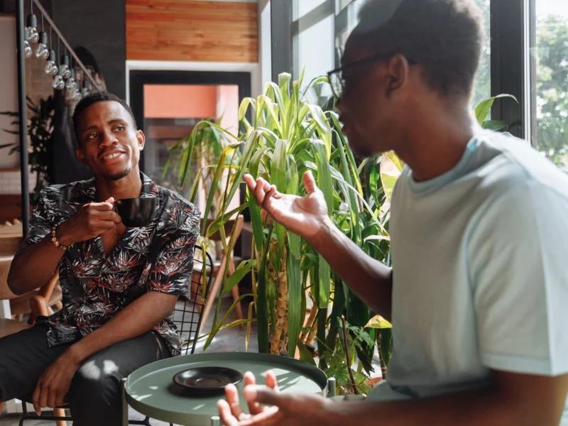 Two friends talking over coffee in a café