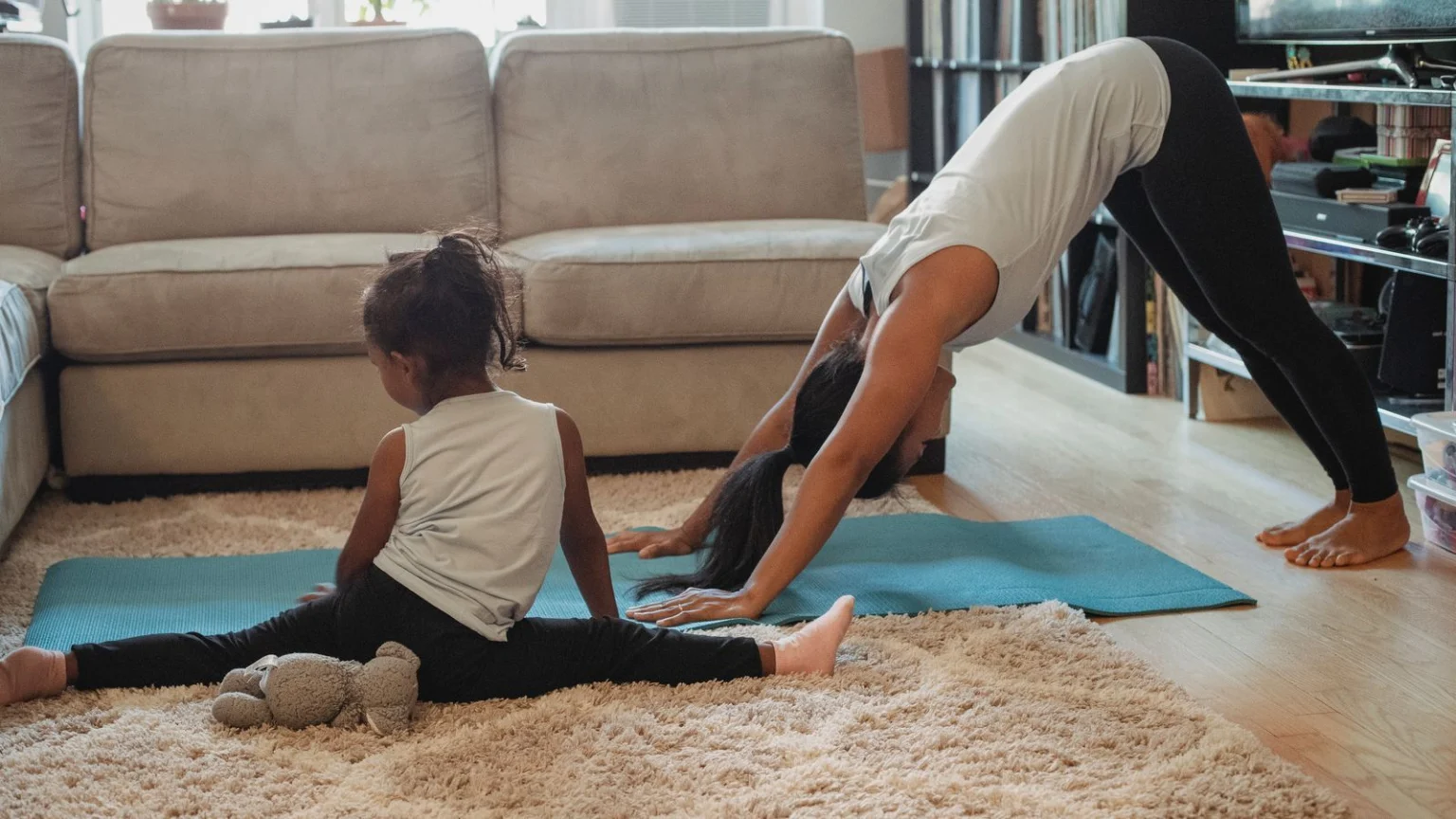 Parent and child stretching together at home