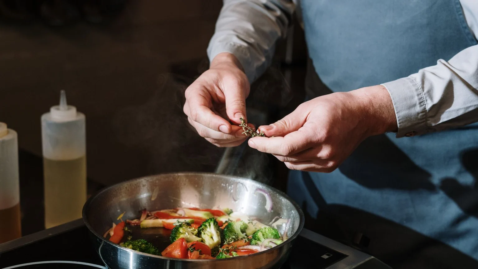 Vegetable stir-fry being seasoned in a pan